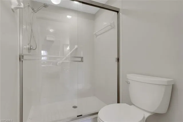 a bathroom with a shower a toilet and sink