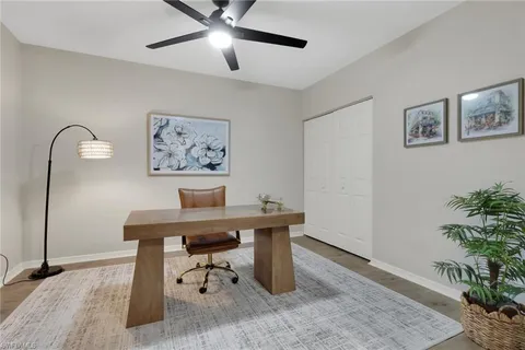 a view of a workspace with furniture and a potted plant