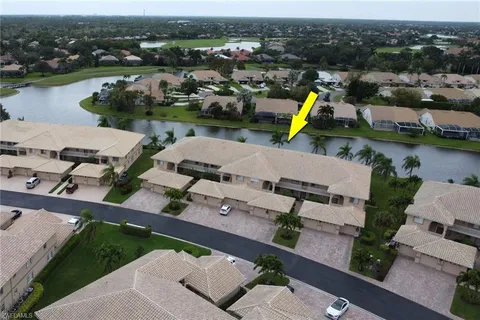 an aerial view of a house with a lake view