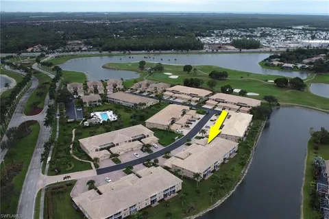 an aerial view of a house with outdoor space and lake view