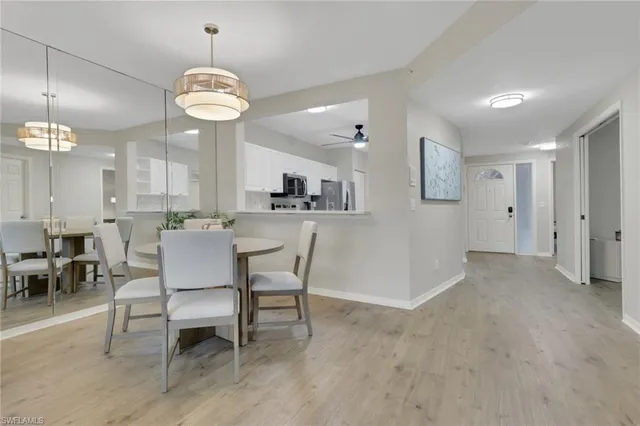 a view of a dining room with furniture and chandelier
