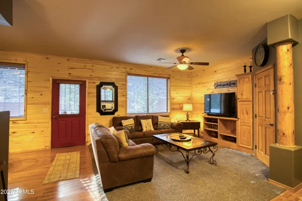 a living room with furniture and a flat screen tv