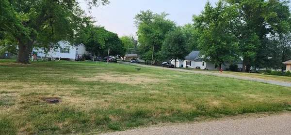 a view of a park with large trees