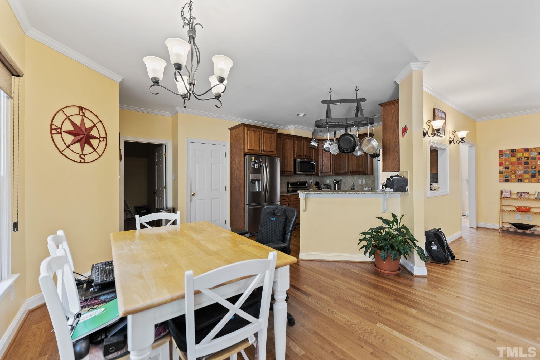 25 Eaglefeather Path Youngsville, NC 27596 - Photo 13 of 36 a view of a dining room with furniture and wooden floor