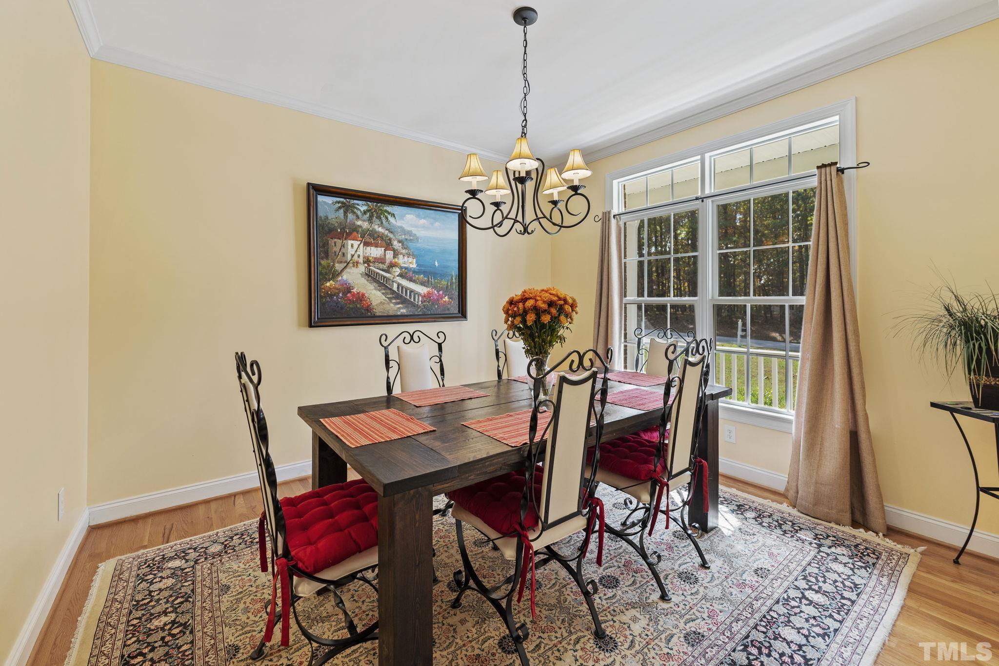 25 Eaglefeather Path Youngsville, NC 27596 - Photo 14 of 36 a view of a dining room with furniture window and wooden floor