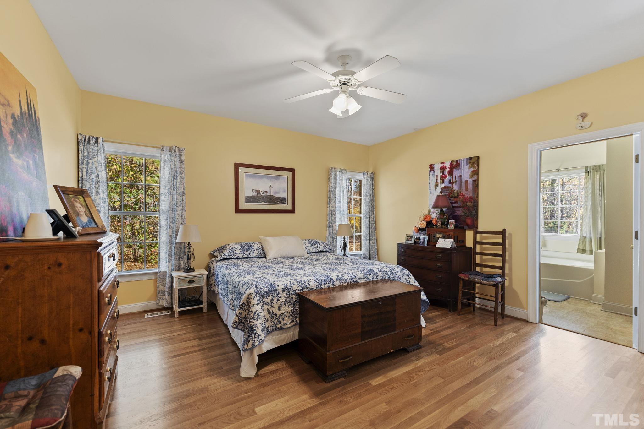 25 Eaglefeather Path Youngsville, NC 27596 - Photo 15 of 36 a bedroom with a bed and wooden floor