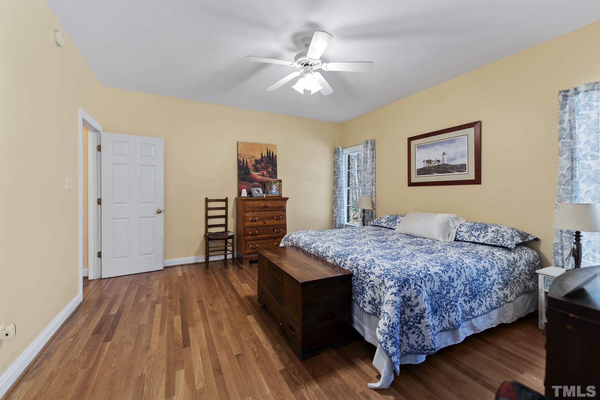 25 Eaglefeather Path Youngsville, NC 27596 - Photo 16 of 36 a bedroom with a bed and a chandelier