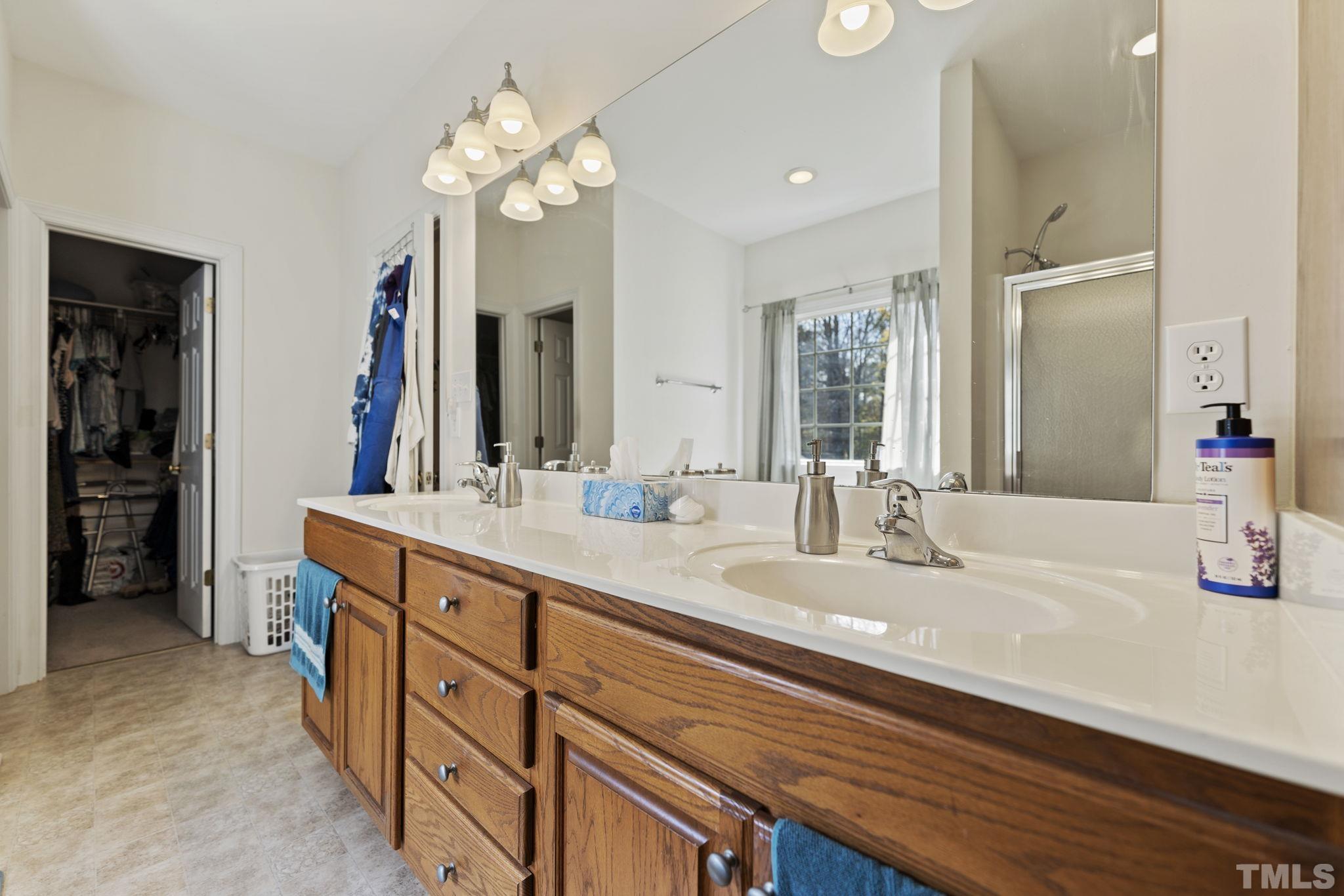 25 Eaglefeather Path Youngsville, NC 27596 - Photo 18 of 36 a bathroom with a double vanity sink and a mirror