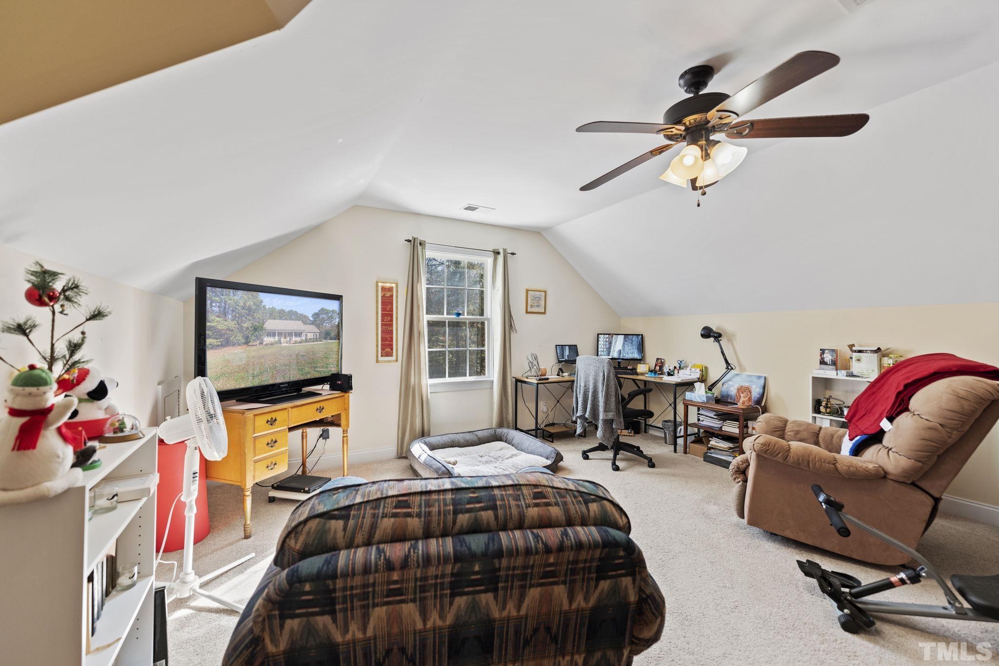 25 Eaglefeather Path Youngsville, NC 27596 - Photo 21 of 36 a bedroom with furniture and a flat screen tv