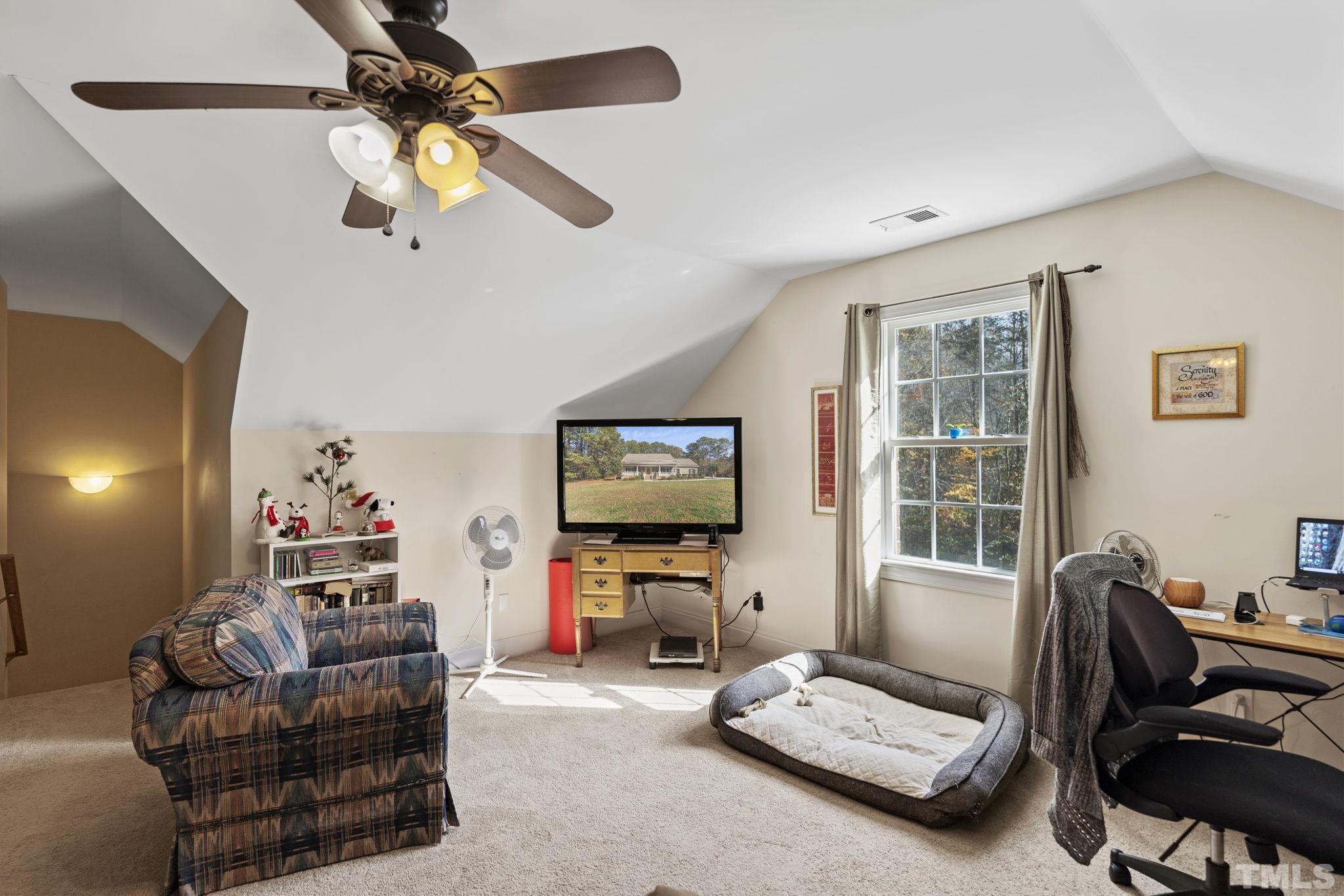 25 Eaglefeather Path Youngsville, NC 27596 - Photo 22 of 36 a living room with furniture and a flat screen tv