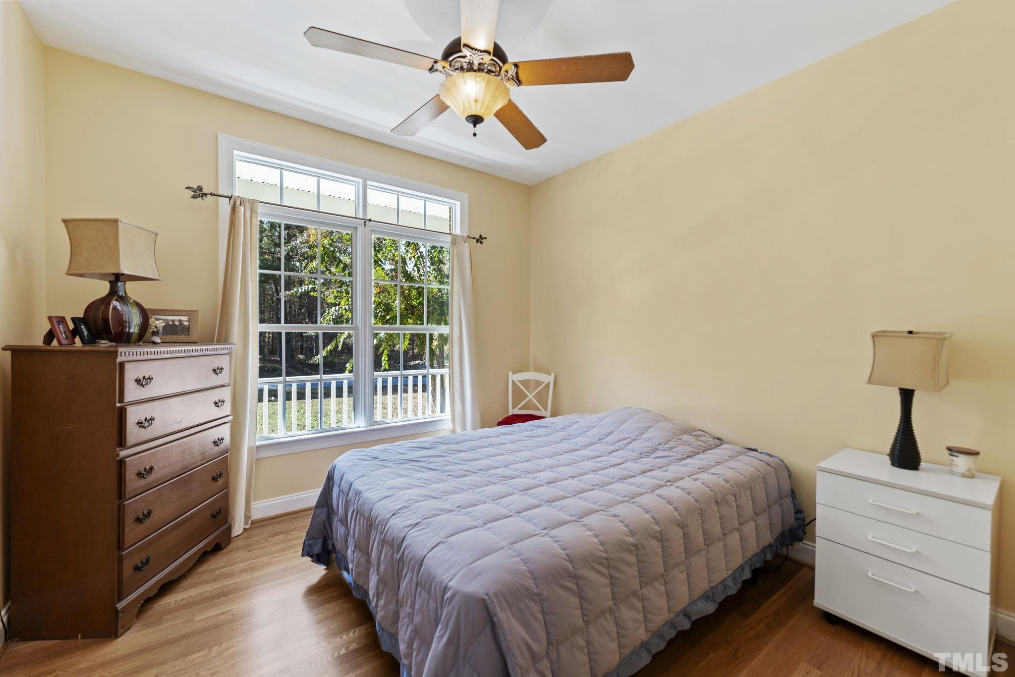 25 Eaglefeather Path Youngsville, NC 27596 - Photo 23 of 36 a bedroom with a bed and a chandelier