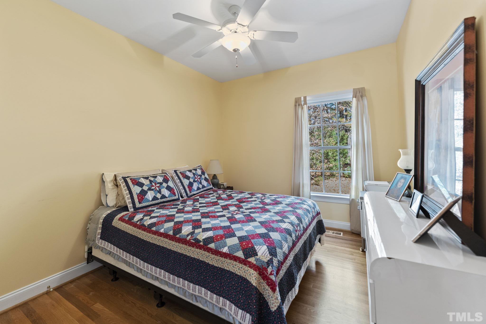 25 Eaglefeather Path Youngsville, NC 27596 - Photo 24 of 36 a bedroom with a bed couch and a window