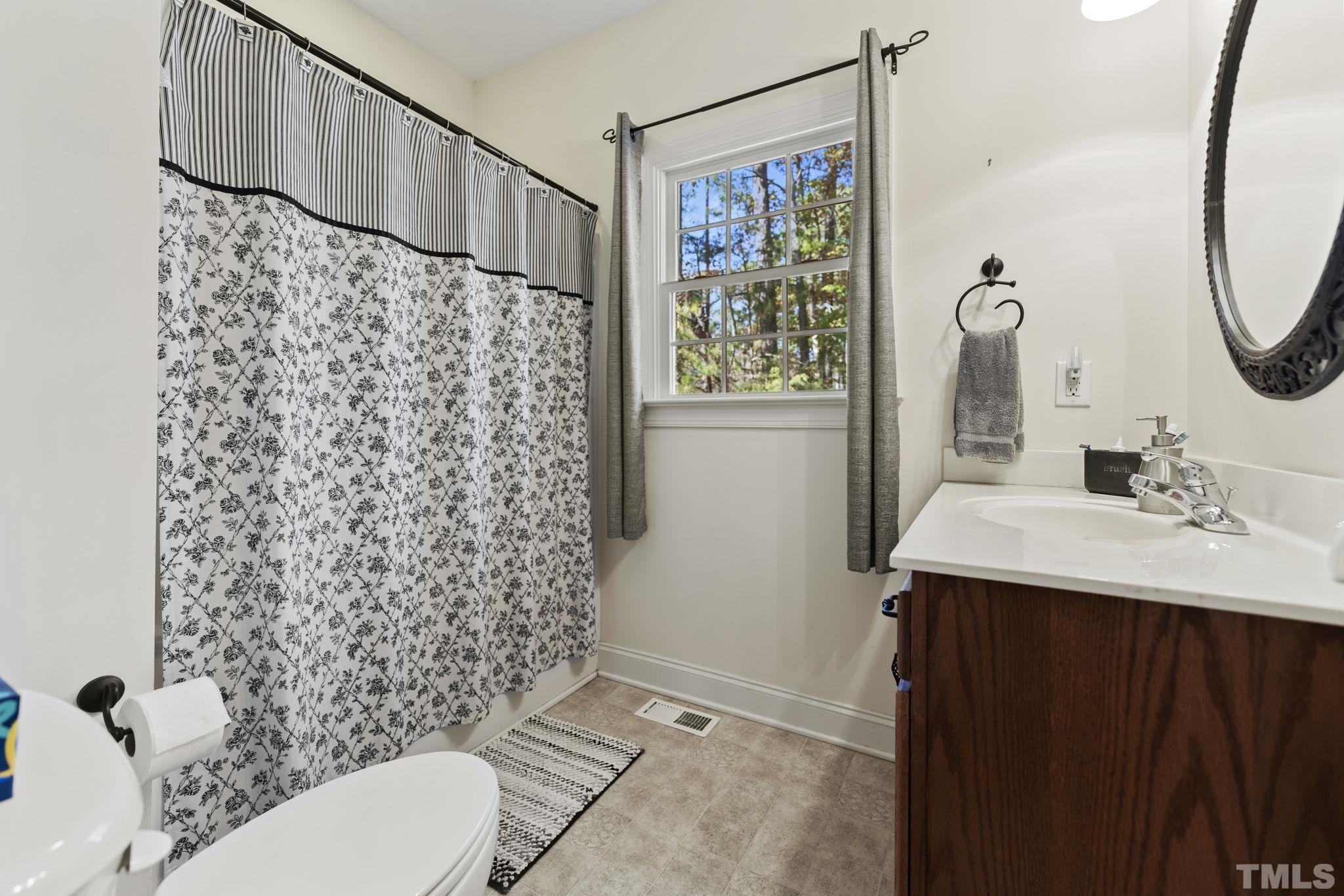 25 Eaglefeather Path Youngsville, NC 27596 - Photo 25 of 36 a bathroom with a sink toilet and shower