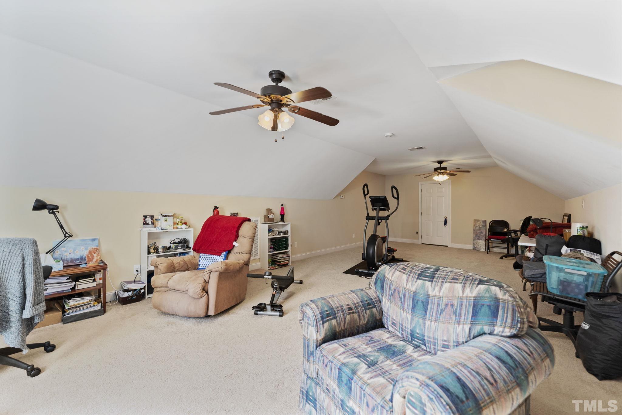25 Eaglefeather Path Youngsville, NC 27596 - Photo 26 of 36 a bedroom with furniture and a chandelier