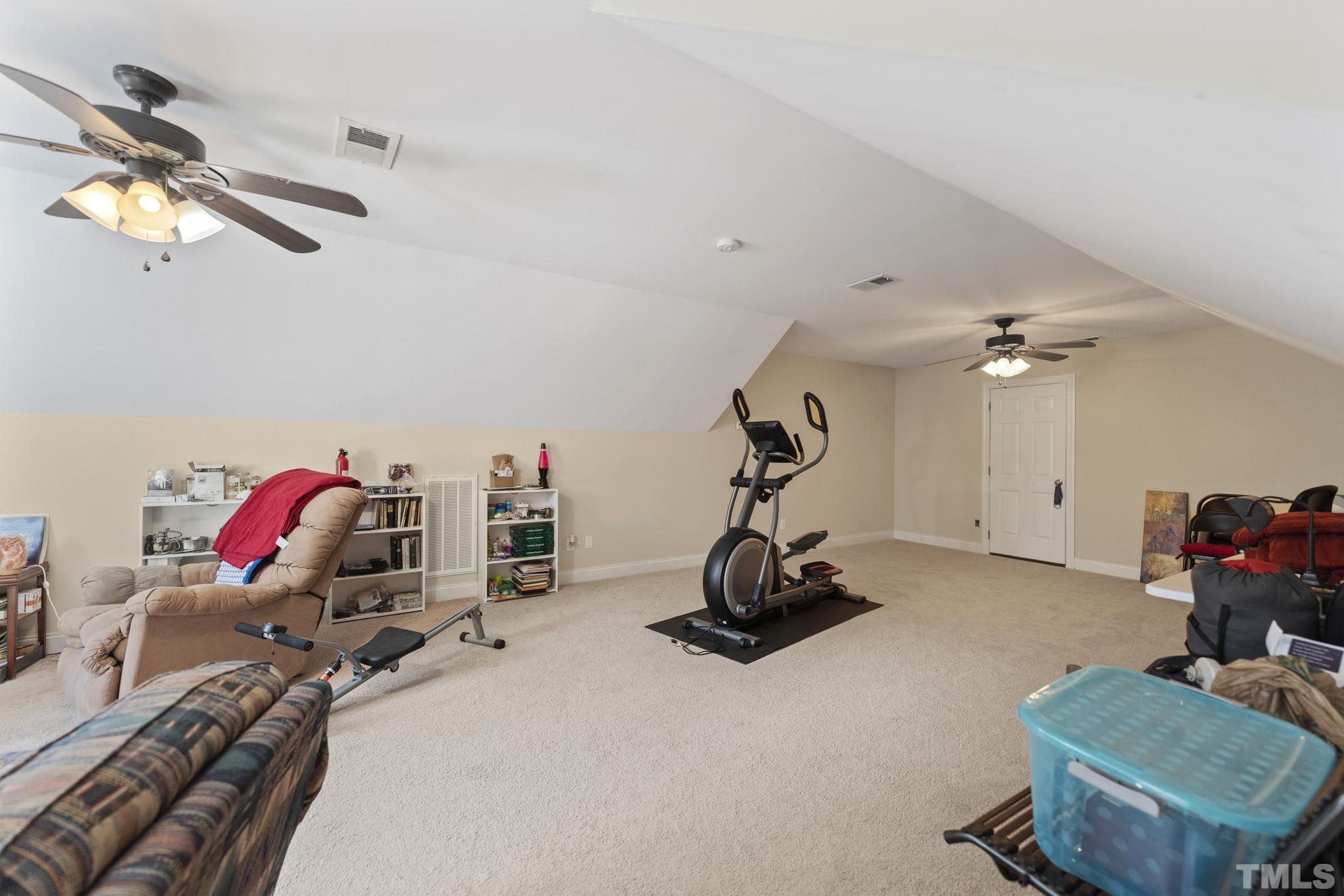 25 Eaglefeather Path Youngsville, NC 27596 - Photo 28 of 36 a view of a room with gym equipment