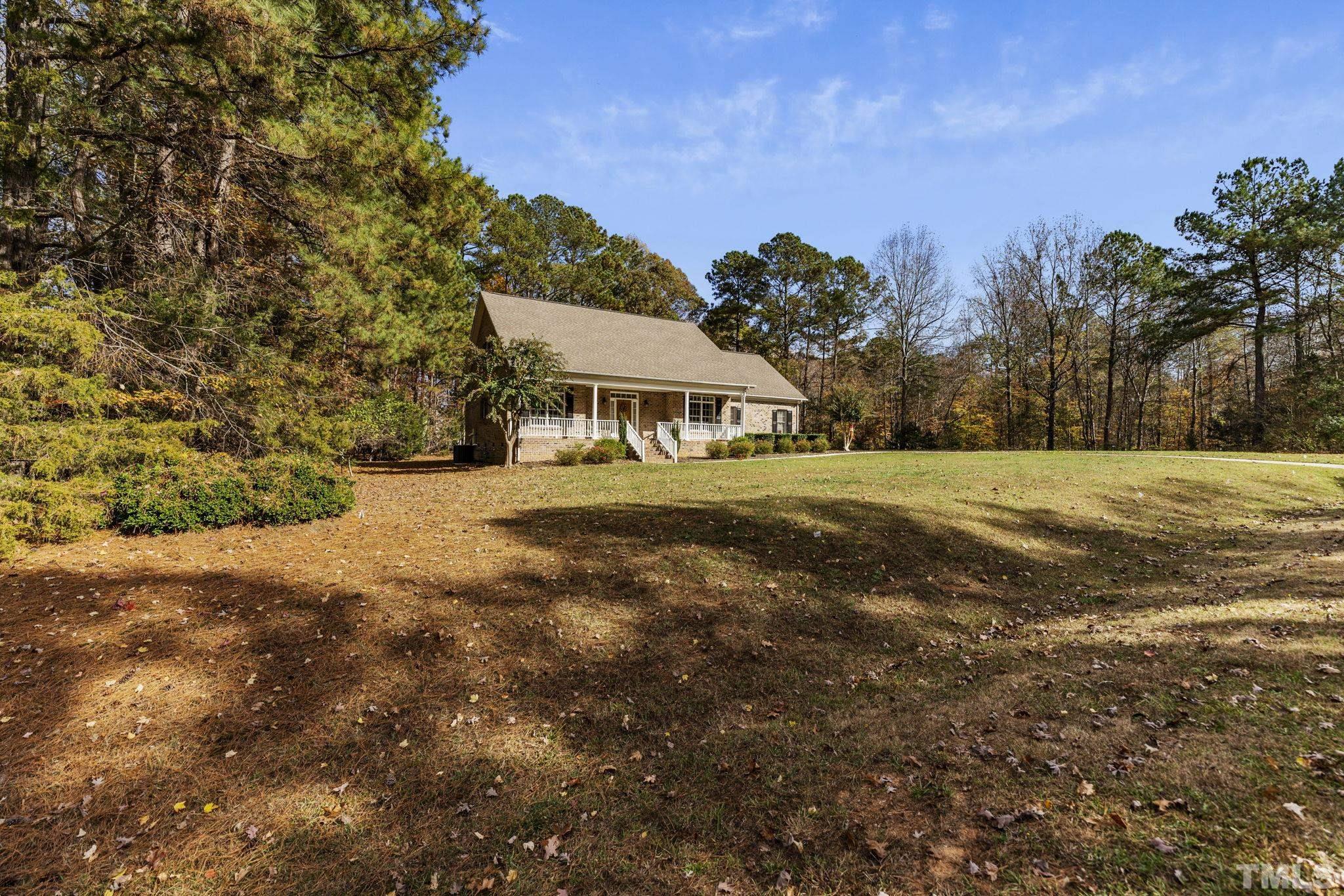 25 Eaglefeather Path Youngsville, NC 27596 - Photo 3 of 36 a view of an house with backyard and trees