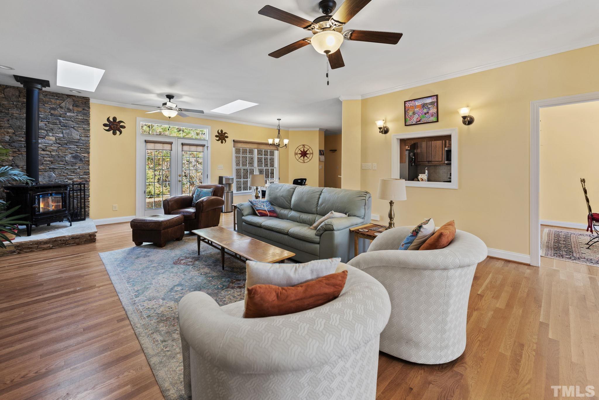 25 Eaglefeather Path Youngsville, NC 27596 - Photo 4 of 36 a living room with furniture wooden floor and a flat screen tv