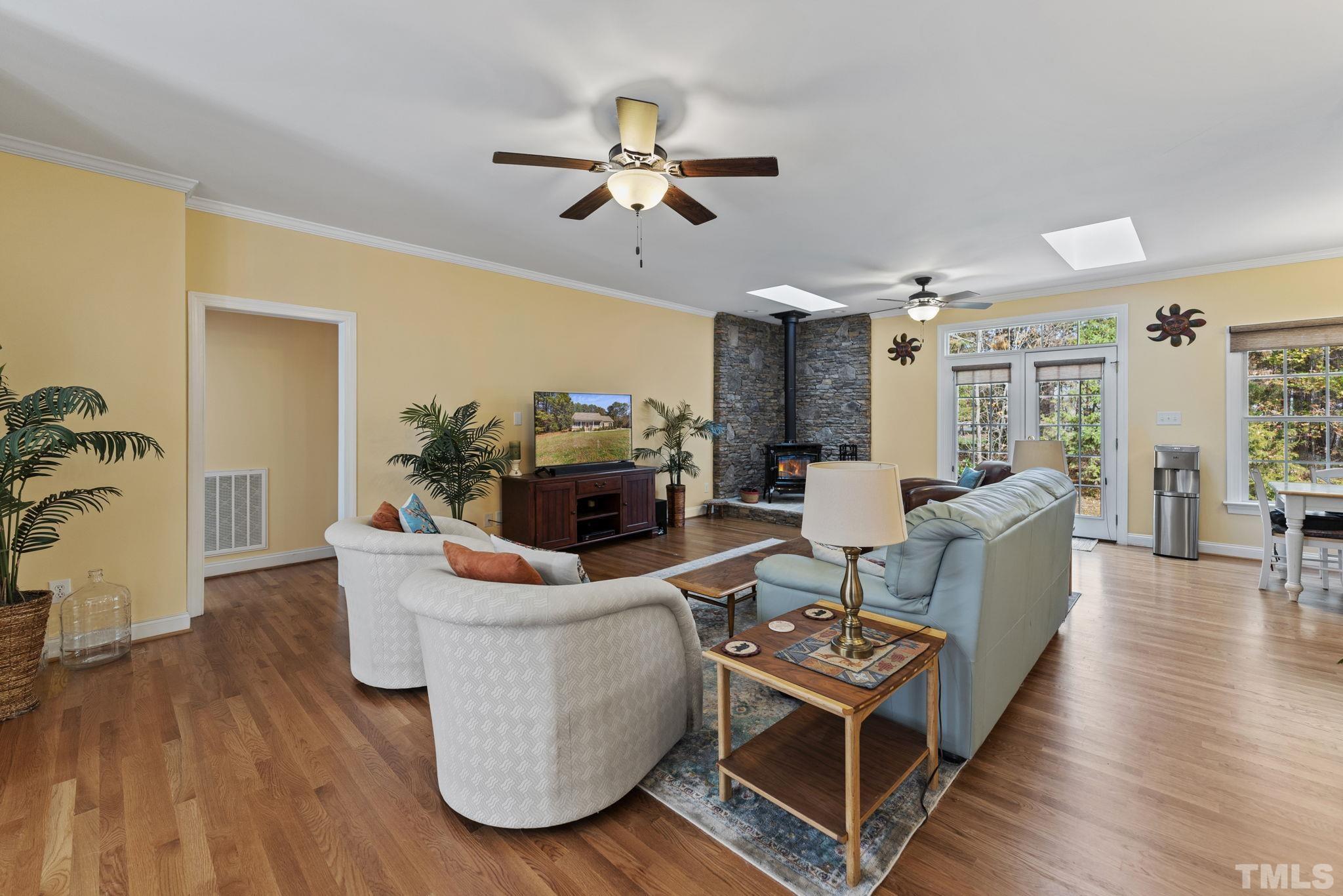 25 Eaglefeather Path Youngsville, NC 27596 - Photo 5 of 36 a living room with furniture and a wooden floor