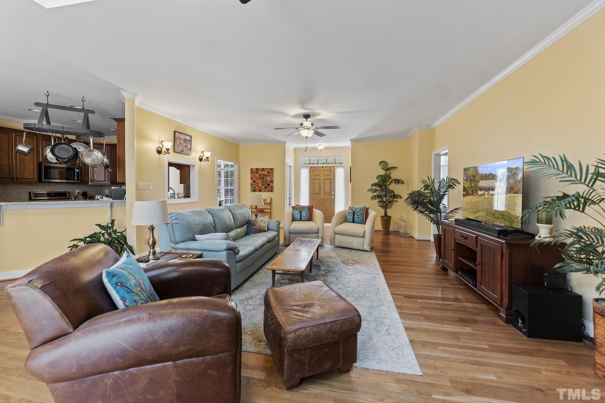 25 Eaglefeather Path Youngsville, NC 27596 - Photo 6 of 36 a living room with furniture and a chandelier