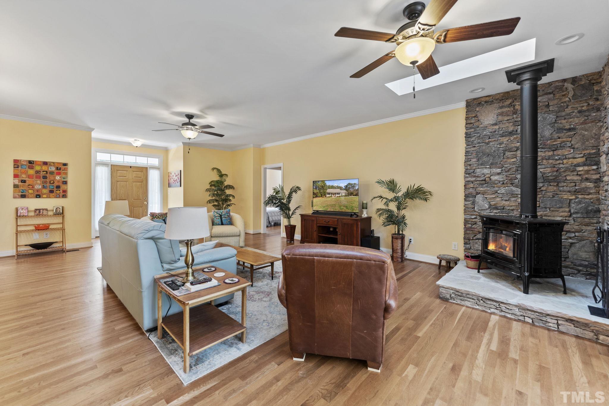 25 Eaglefeather Path Youngsville, NC 27596 - Photo 7 of 36 a living room with furniture and a fireplace