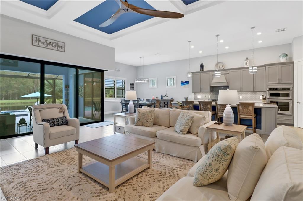 14236 Moonlit Way Estero, FL 33928 - Photo 11 of 46 a living room with furniture kitchen view and large windows
