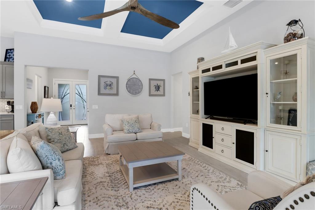 14236 Moonlit Way Estero, FL 33928 - Photo 13 of 46 a living room with furniture and a flat screen tv