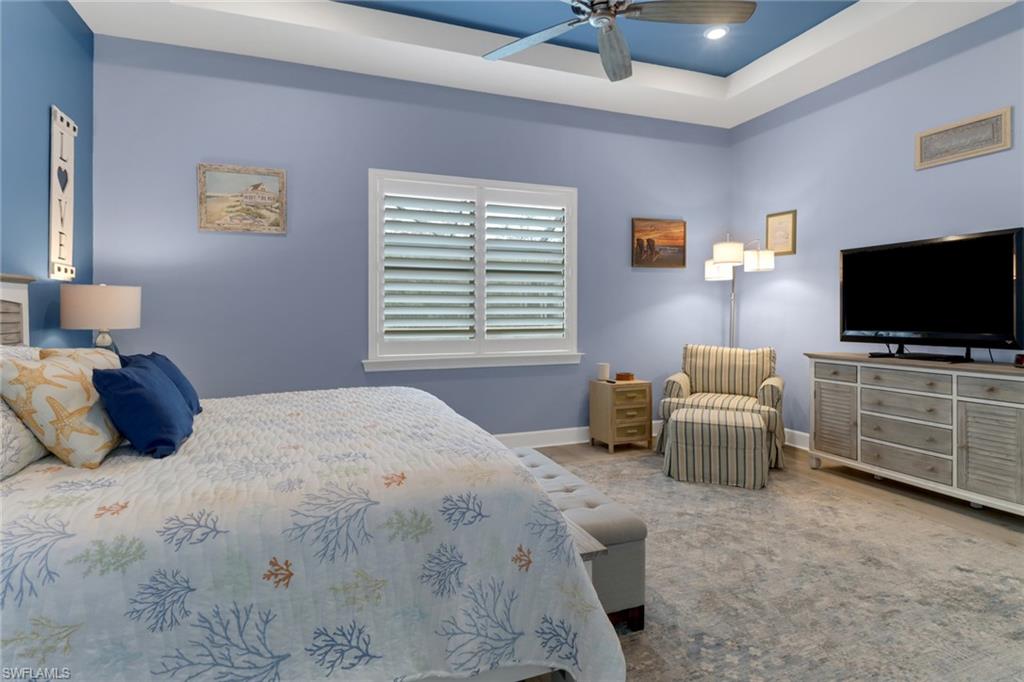 14236 Moonlit Way Estero, FL 33928 - Photo 15 of 46 a bedroom with a bed and a flat screen tv
