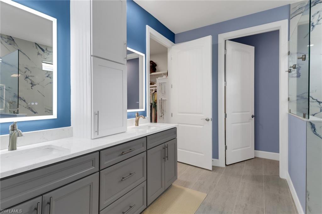 14236 Moonlit Way Estero, FL 33928 - Photo 17 of 46 a bathroom with a sink and two mirror