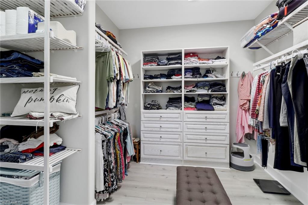 14236 Moonlit Way Estero, FL 33928 - Photo 18 of 46 a view of walk in closet with clothes and shoes