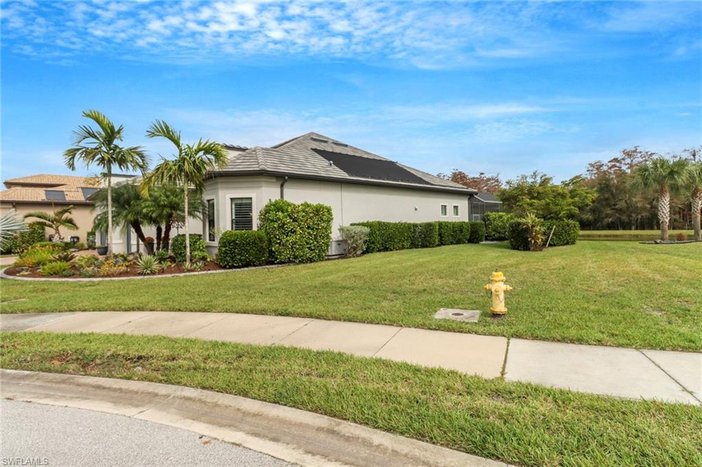 14236 Moonlit Way Estero, FL 33928 - Photo 2 of 46 a view of a house with a yard