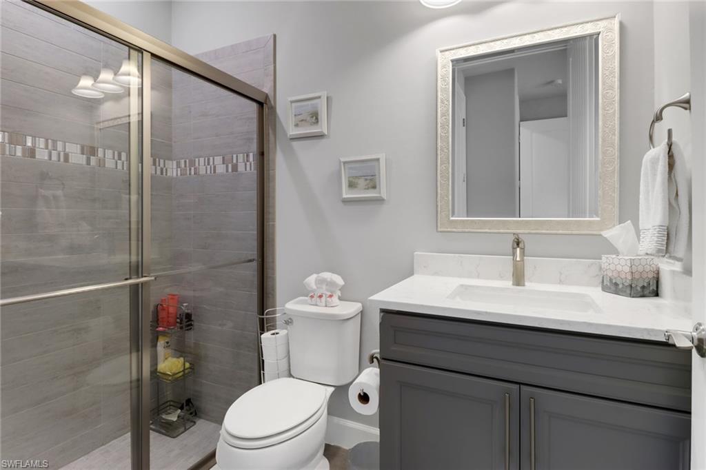 14236 Moonlit Way Estero, FL 33928 - Photo 21 of 46 a bathroom with a sink a toilet and shower