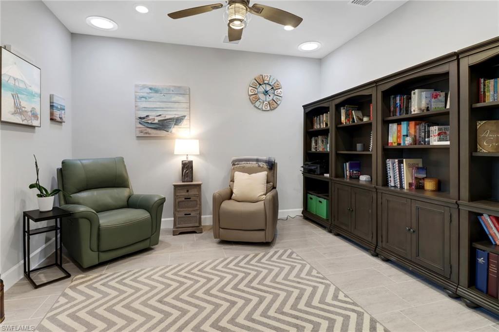 14236 Moonlit Way Estero, FL 33928 - Photo 22 of 46 a living room with furniture and a book shelf