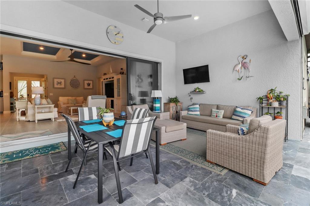 14236 Moonlit Way Estero, FL 33928 - Photo 25 of 46 a living room with furniture and a flat screen tv