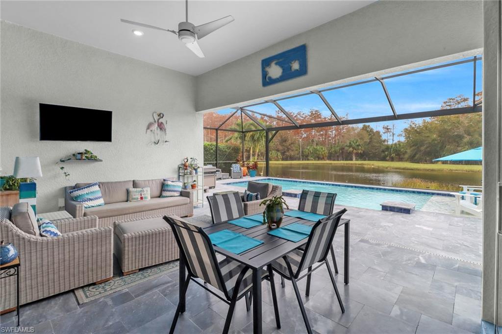 14236 Moonlit Way Estero, FL 33928 - Photo 26 of 46 a dining room with furniture and a floor to ceiling window