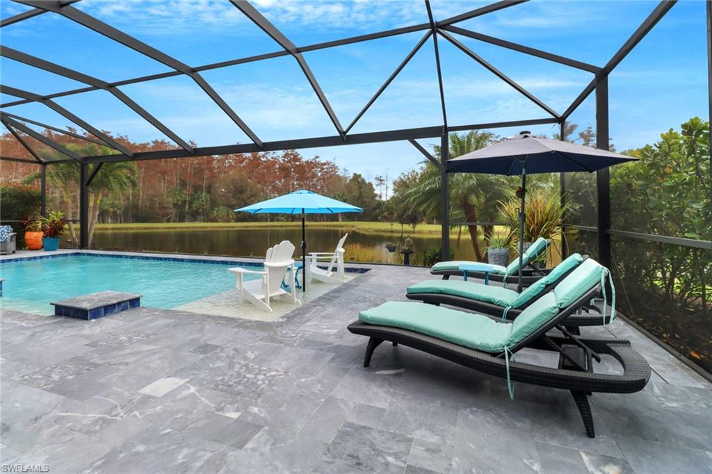 14236 Moonlit Way Estero, FL 33928 - Photo 29 of 46 an outdoor sitting area with chairs and table