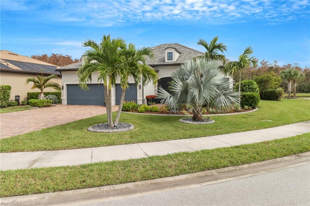 14236 Moonlit Way Estero, FL 33928 - Photo 3 of 46 a front view of a house with garden