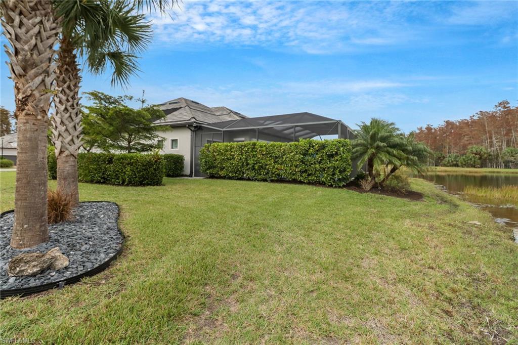 14236 Moonlit Way Estero, FL 33928 - Photo 33 of 46 a view of a garden with a building in the background