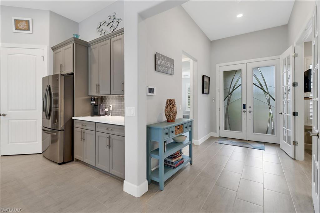 14236 Moonlit Way Estero, FL 33928 - Photo 5 of 46 a kitchen with stainless steel appliances a refrigerator and a stove top oven
