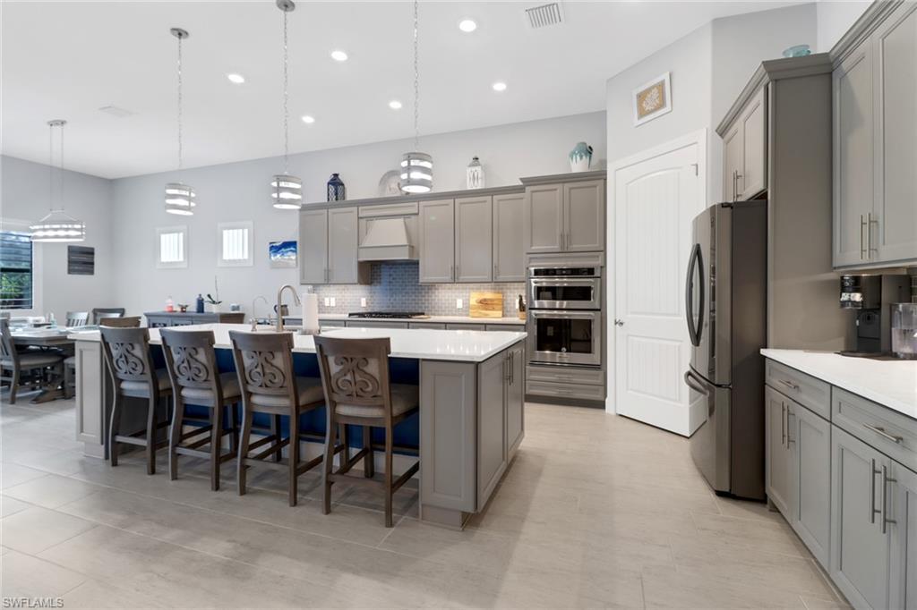14236 Moonlit Way Estero, FL 33928 - Photo 8 of 46 a large kitchen with a large counter top appliances and cabinets