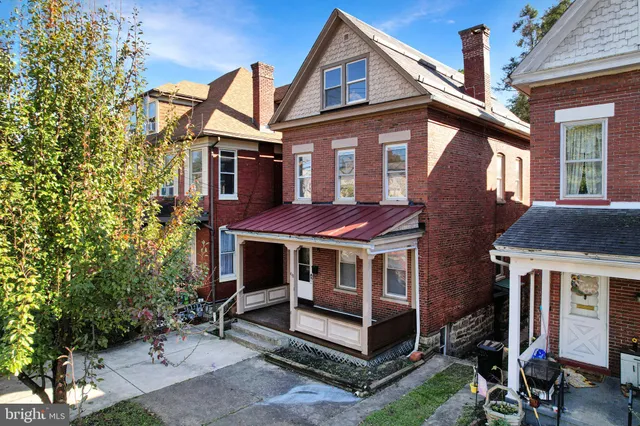 a view of a house with a yard porch and furniture