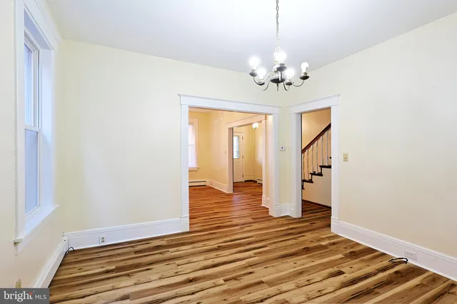 a view of a livingroom with wooden floor and closet
