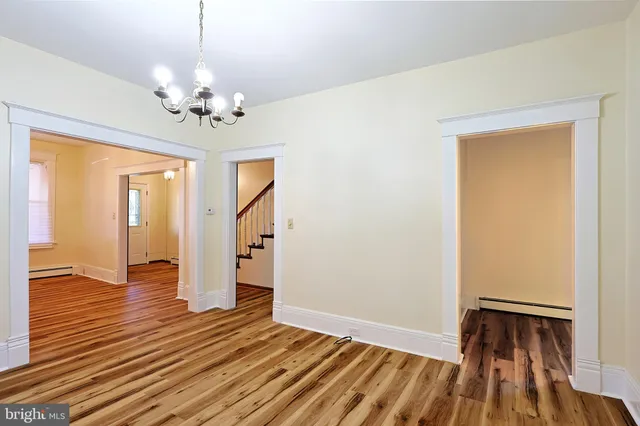 a kitchen with a sink a stove a refrigerator and white cabinets