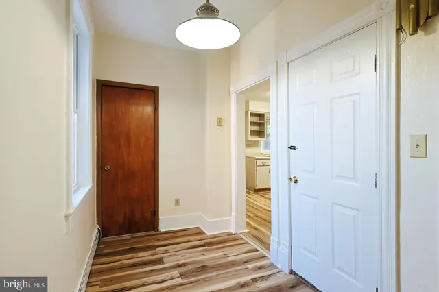 a kitchen with a stove cabinets and white appliances