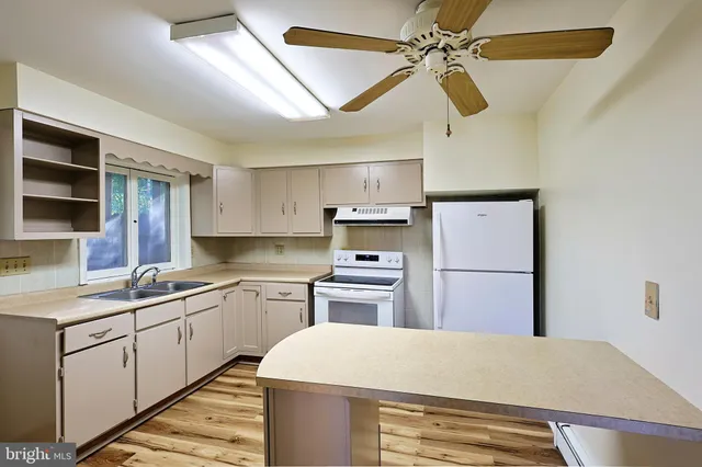 a bathroom with a sink mirror vanity and a bathtub