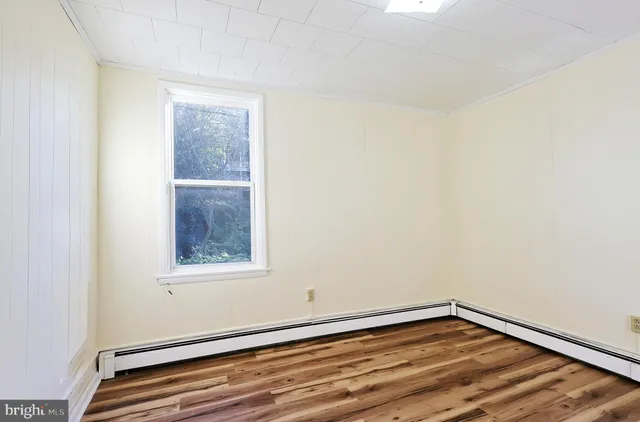 a view of walk in closet with wooden floor