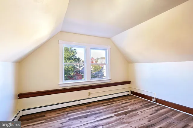 a view of a wooden door with a house and a yard