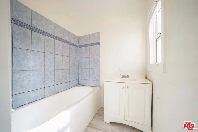 a bathroom with a bathtub and shower