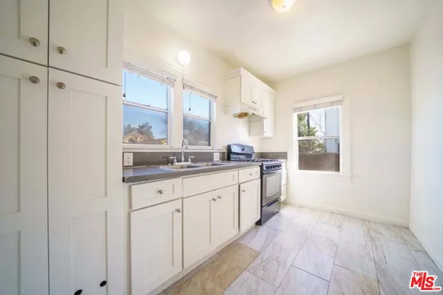 a large bathroom with a granite countertop sink