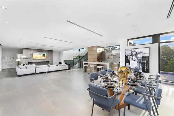 a large white kitchen with stainless steel appliances