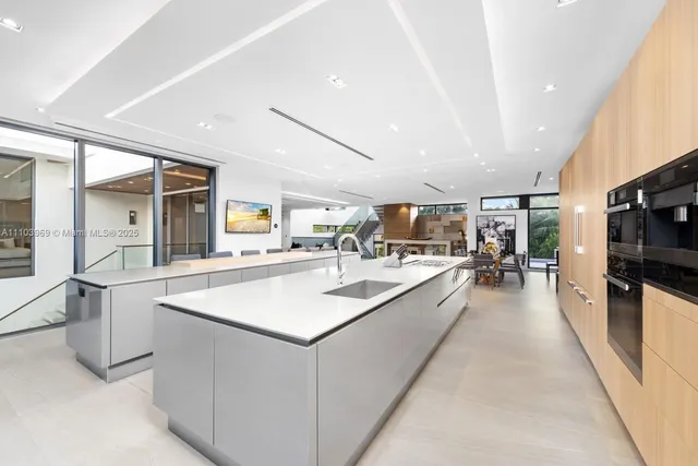 a kitchen with stainless steel appliances kitchen island a large island in the center